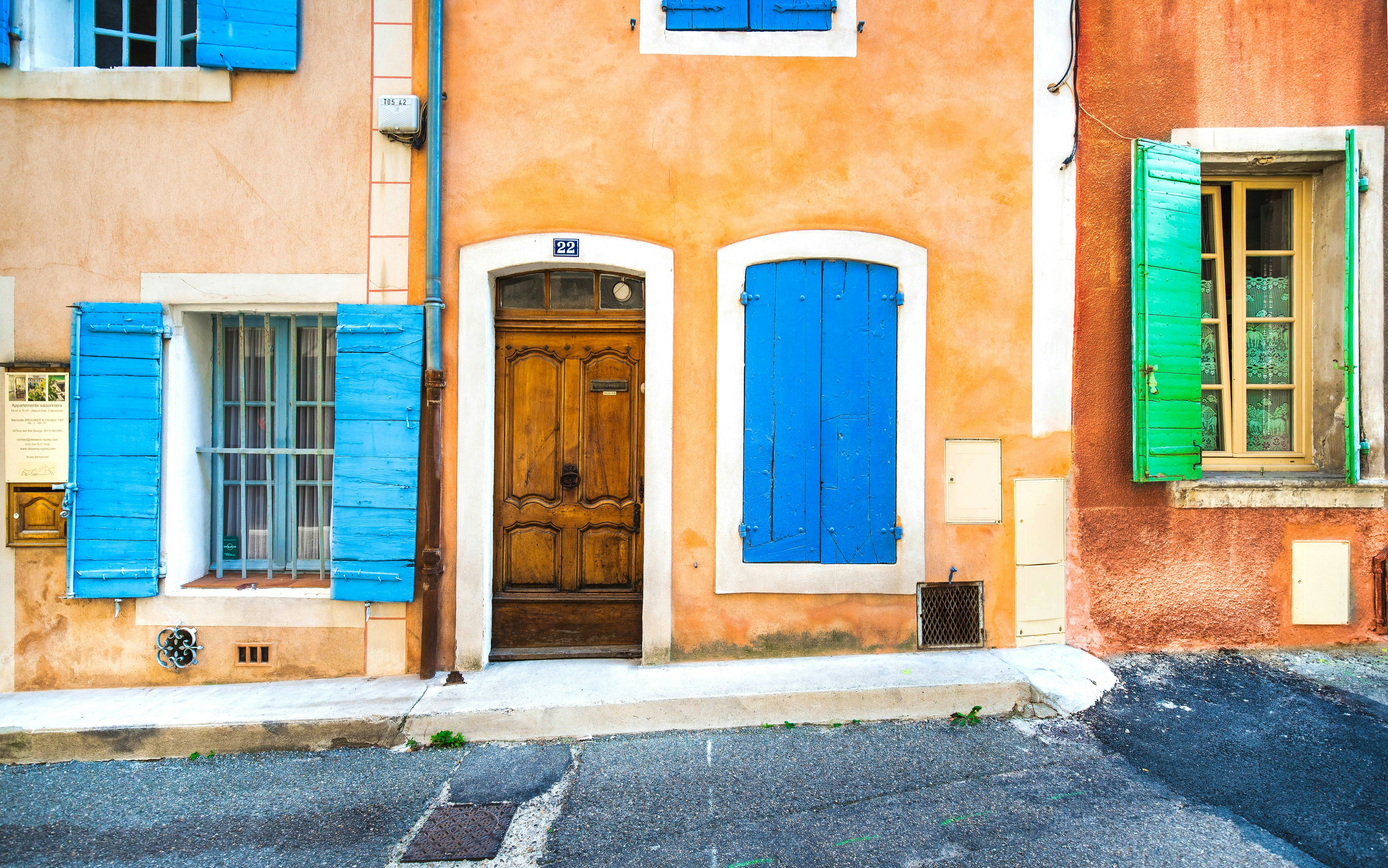 blue wooden door on brown concrete building